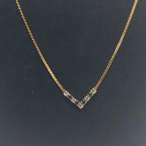 Gold tone V white, blue crystal necklace